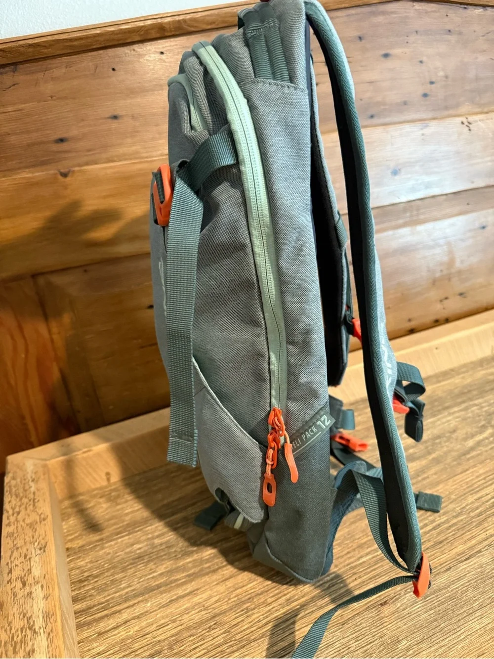 Dakine Mint tinted heli pack 12 backpack with Orange Buckles